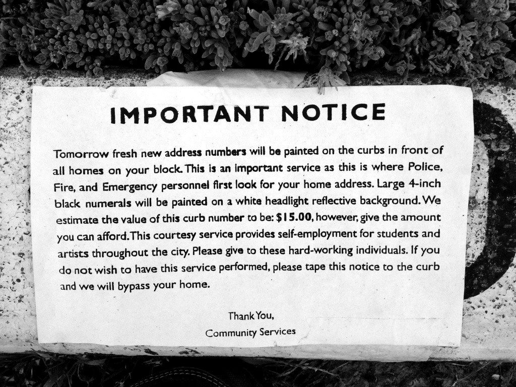 A printed 'important notice' scam flyer asking residents for money