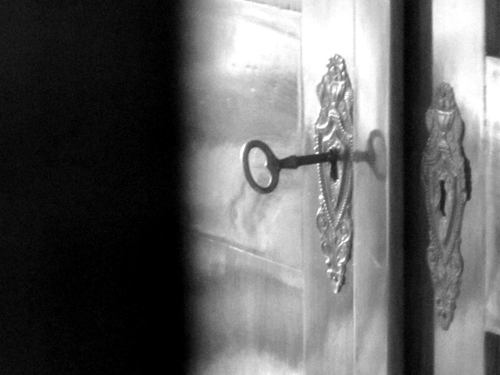 A key in the lock of an antique cabinet door