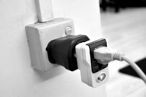 A plug adapter fitted into a wall socket