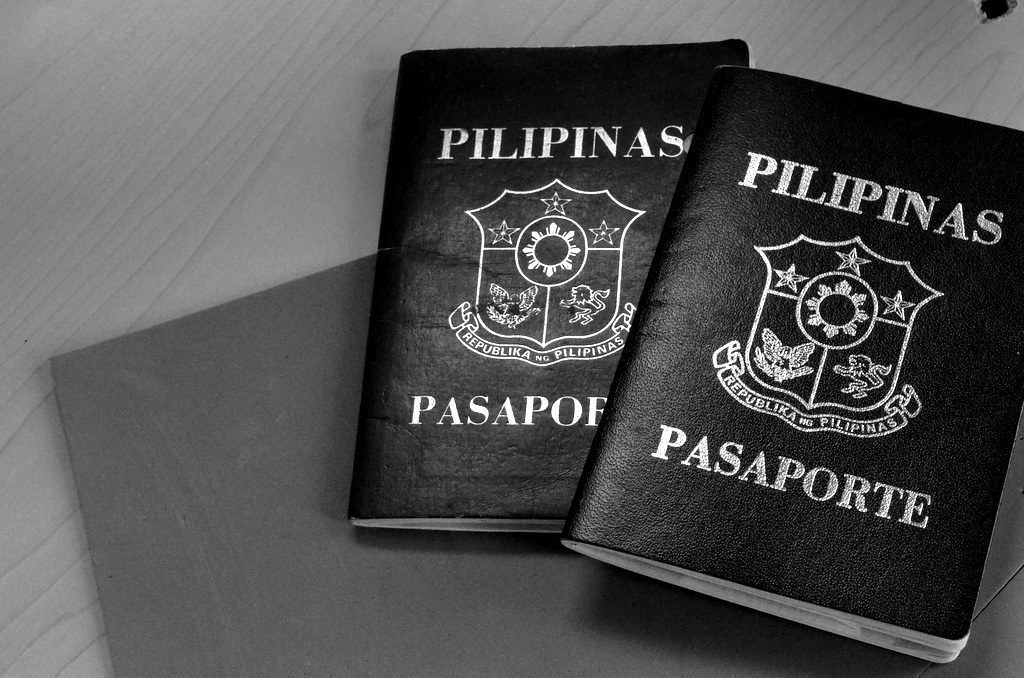 Two Philippine passports on a blue folder