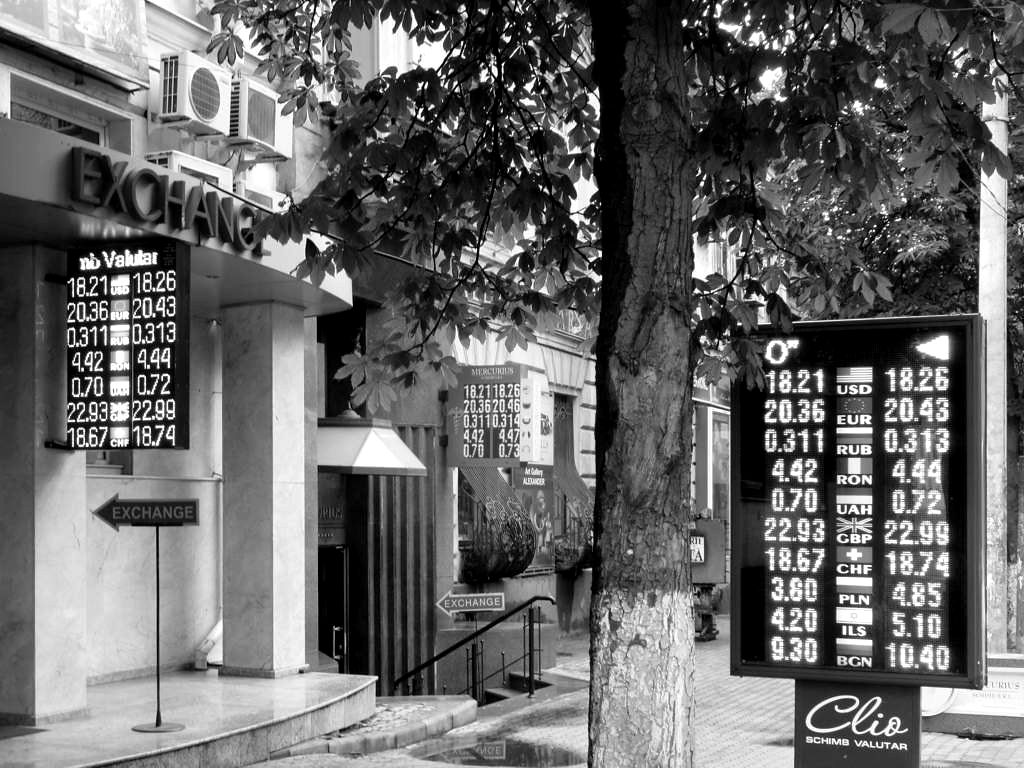 A street currency-exchange board showing buy and sell rates