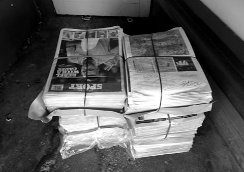 Bundles of newspapers tied together with tape