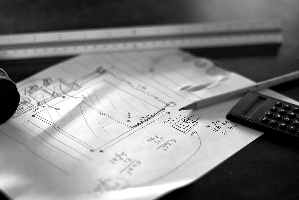 Loan calculations sketched on paper with a pencil, ruler and calculator