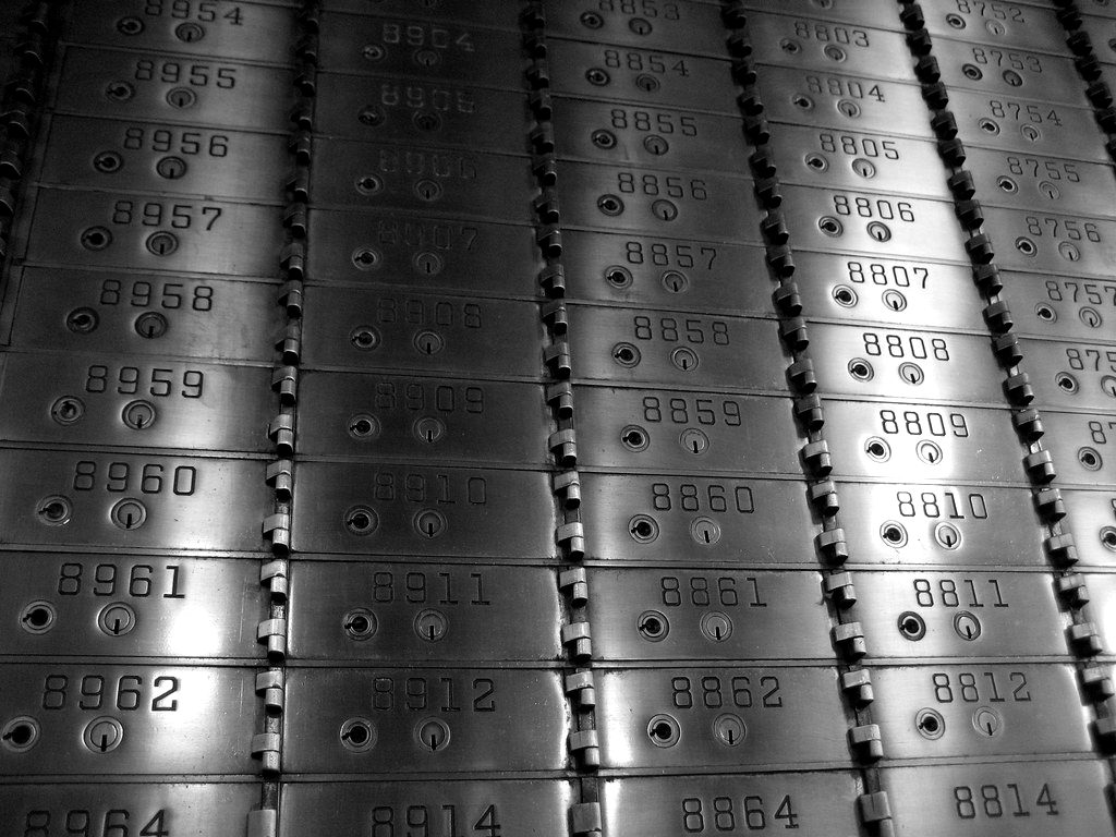 Rows of numbered safe deposit boxes in a bank vault