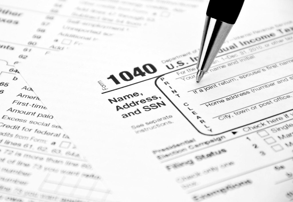 A pen over a US Form 1040 individual income tax return
