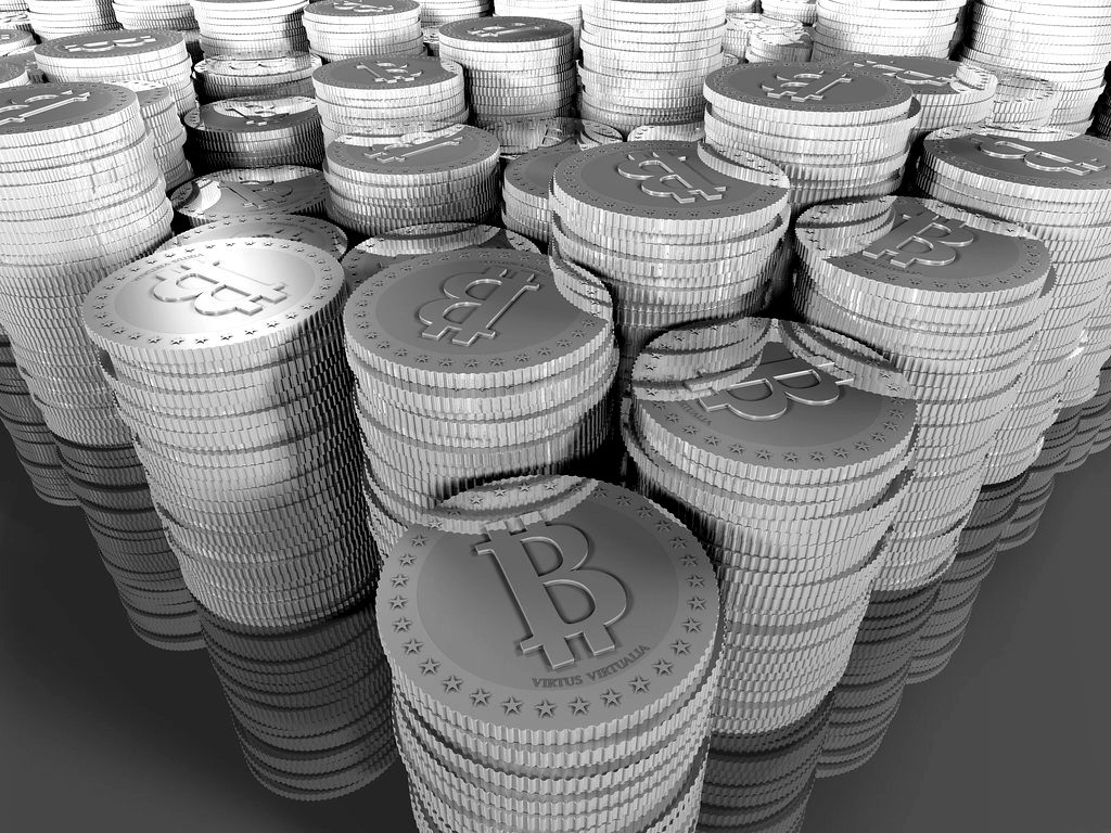 Stacks of silver and gold commemorative Bitcoin coins