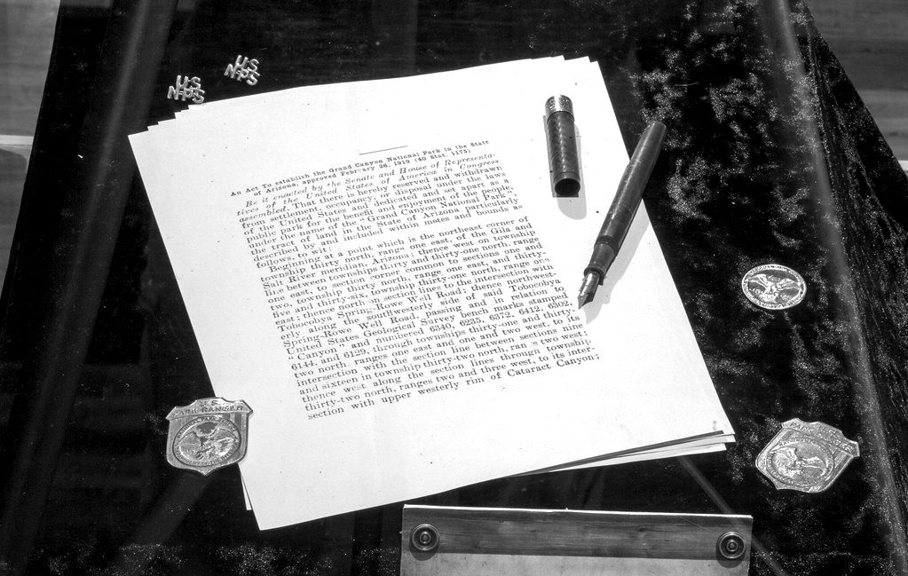 Typed pages and a fountain pen on a dark marble desk