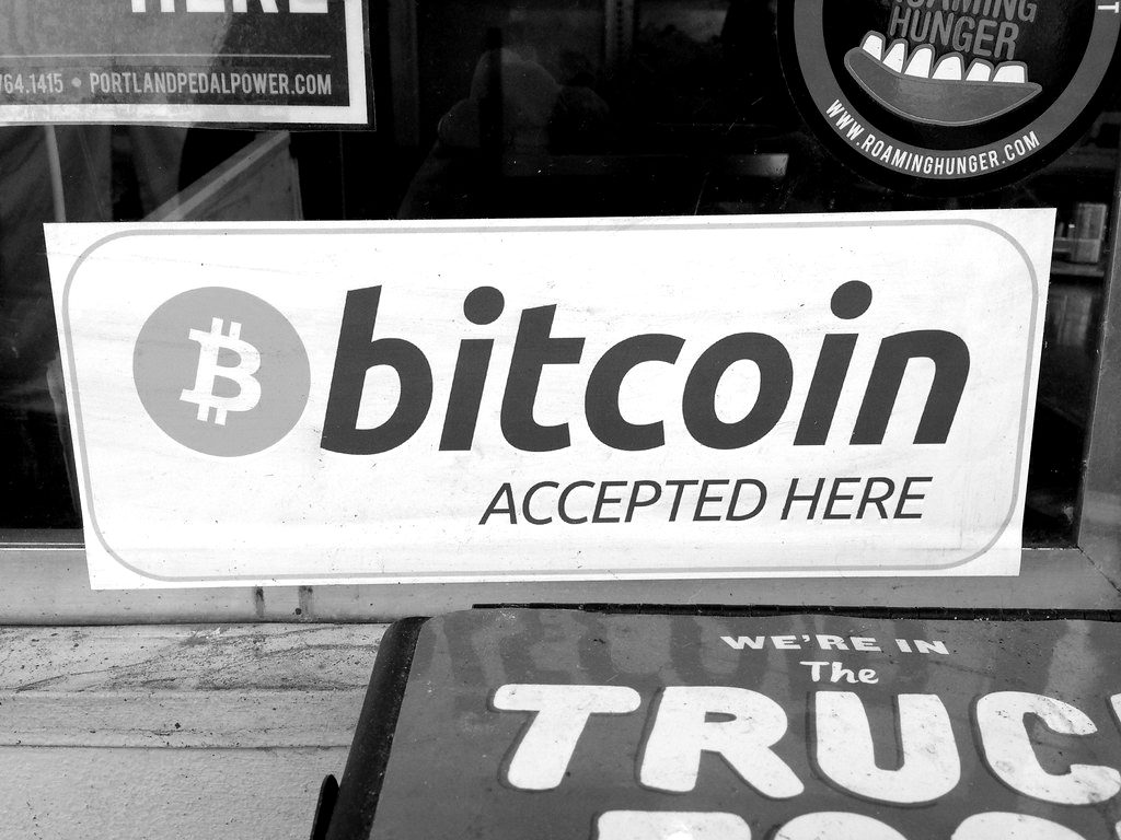 A 'Bitcoin accepted here' sign in a shop window