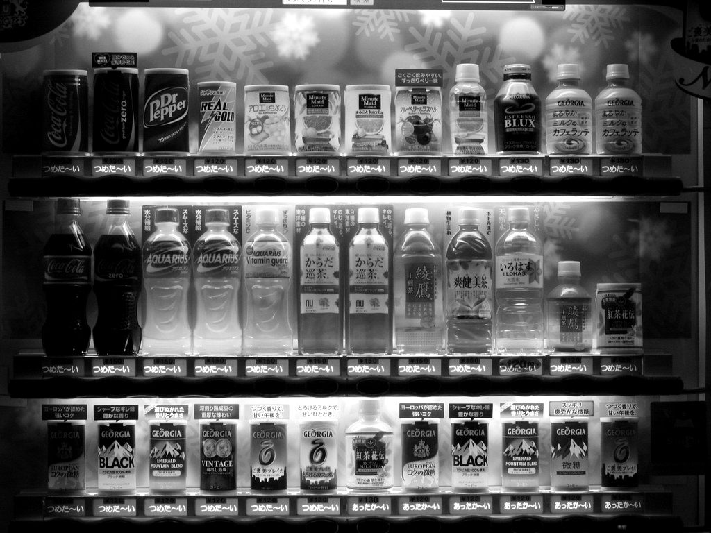 A vending machine stocked with rows of drinks
