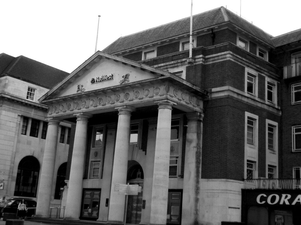 A bank branch with classical columns on a city street