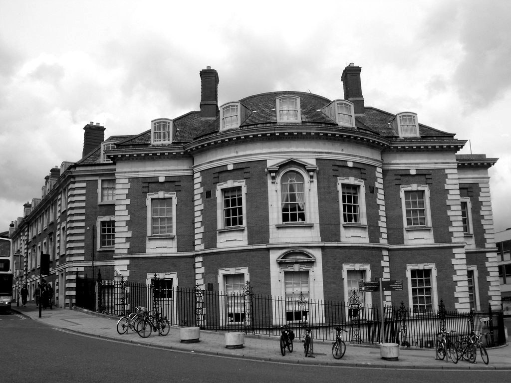 A red-brick Victorian bank building on a street corner
