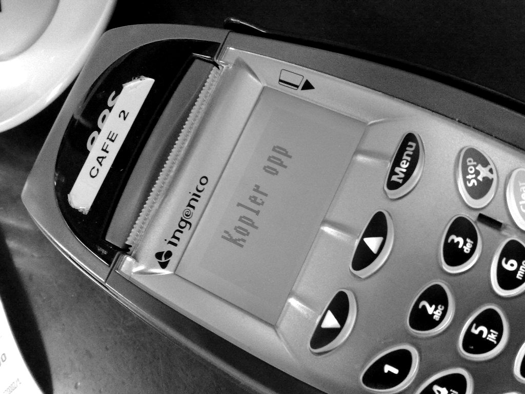 A handheld card machine with illuminated keys