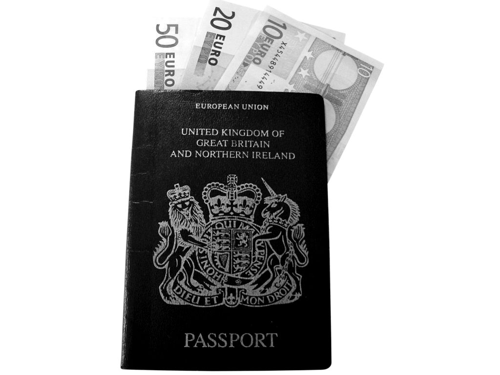 A UK passport with euro banknotes tucked inside