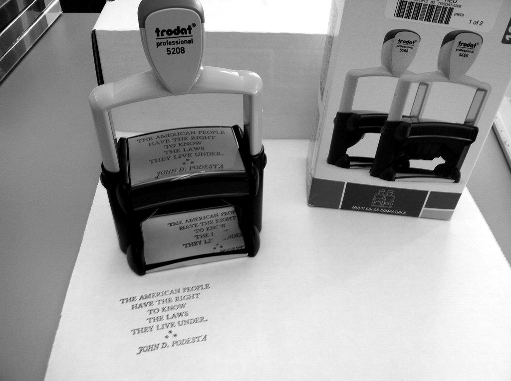 A self-inking stamp beside its box