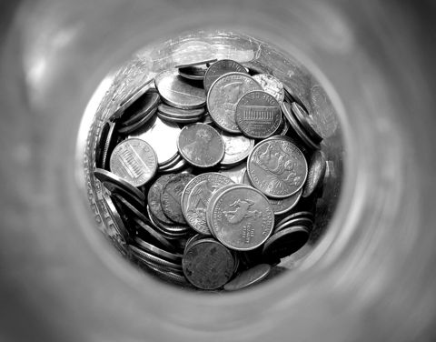 Looking down into a jar filled with saved coins