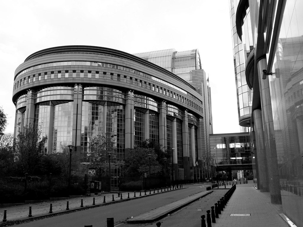 The curved glass facade of the European Parliament in Brussels