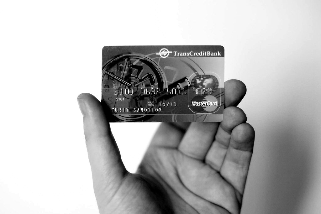 A hand holding a bank payment card