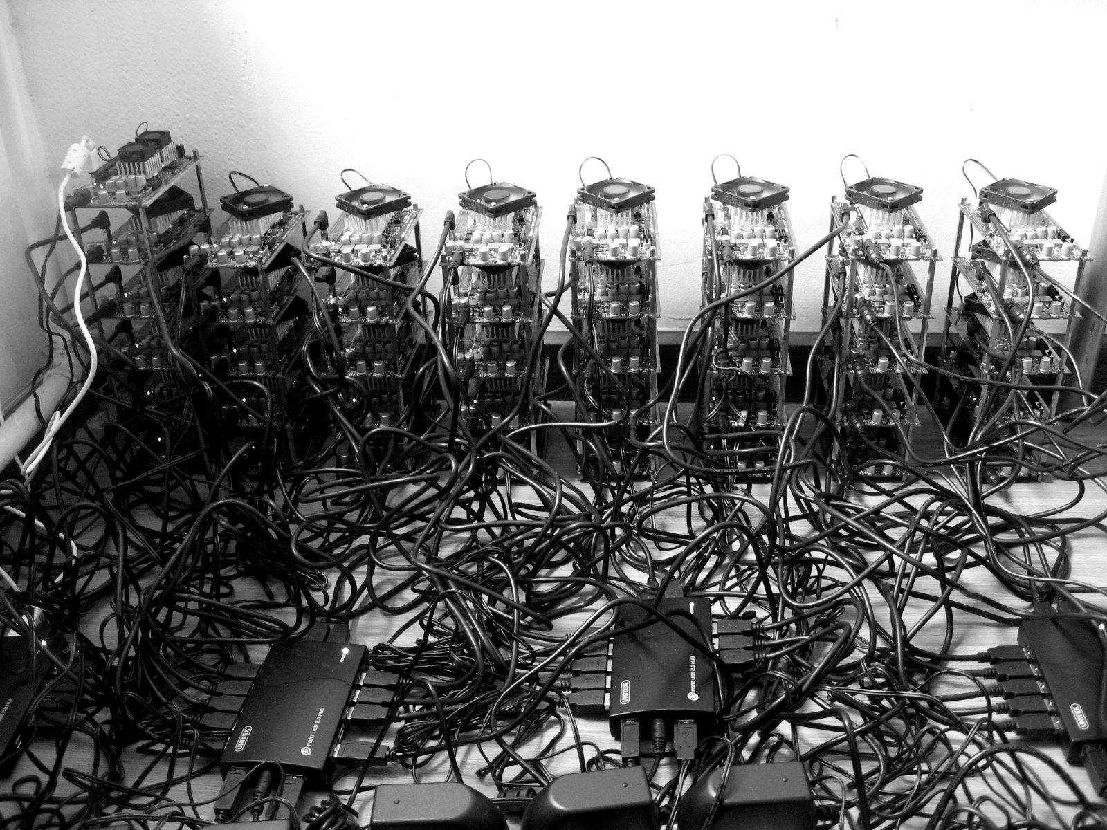 Rows of cryptocurrency mining rigs connected by cables