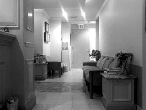 An empty waiting-room corridor with chairs