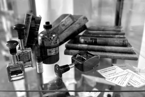 Antique rubber stamps and ink pads in a display case
