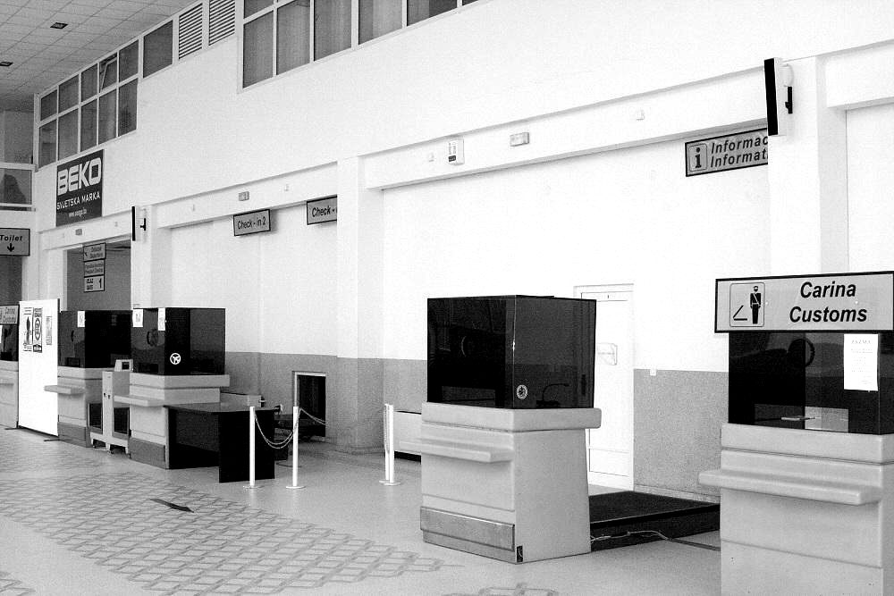 Empty customs desks in an airport arrivals hall