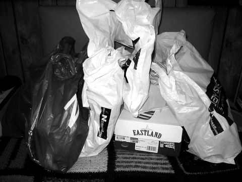 Plastic shopping bags piled on the floor after a shopping trip