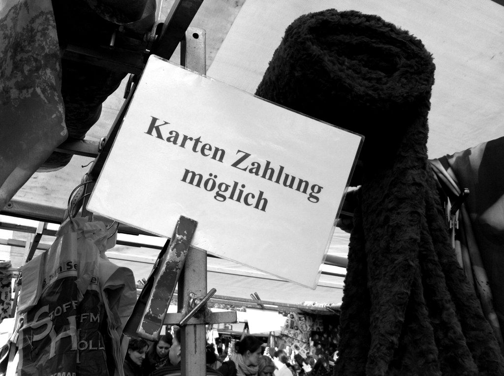 A handwritten 'card payment possible' sign at a market stall